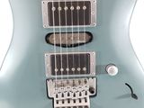 an electric guitar sitting on top of a white surface