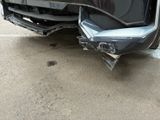 the front bumper of a car with a denting dent on it