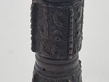 a black vase sitting on top of a white table