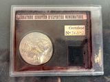a silver coin in a plastic case on a table
