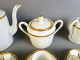 un service à thé blanc et doré, orné de bordures dorées