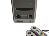 a nintendo classic game console with two controllers next to it