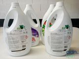 three gallon bottles of liquid sitting on top of a counter
