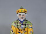 a figurine of a man in a yellow outfit