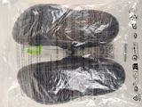 two pairs of shoes in a plastic bag on a table