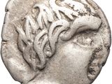 un gros plan d'une pièce de monnaie sur laquelle figure une tête