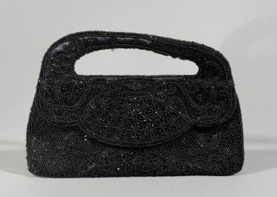 an image of a black beaded purse on a white background