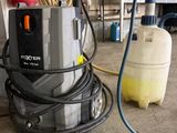 a machine that is sitting on the floor next to a tank