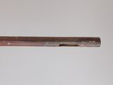 a close up of a gun with a wooden barrel on a white background