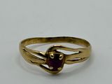 an image of a gold ring with a heart shaped ruby stone