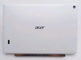 the back of a white laptop computer sitting on top of a table