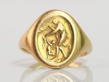 an image of a gold ring with a man and a dog on it