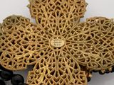 a cross made out of beads and beads on a table