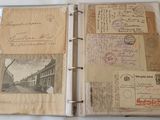 a binder with a lot of old postcards on it