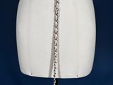 a close up of a mannequin torso with a chain around it