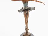 statue of a ballerina in a tutu on a marble base
