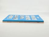 a blue book that is sitting on a white table