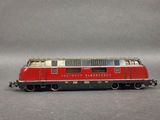 a red and white train car on a gray surface