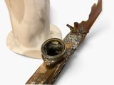 a white hat and a wooden pipe on a table