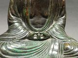 a statue of a person sitting in a lotus position