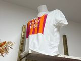 a white t - shirt hanging on a rack in a closet