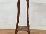a small wooden table with a shelf on top of it