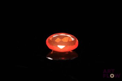 halloween jack o lantern in the dark with a reflection on the ground