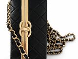a close up of a black purse with a chain around it