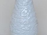 a white lamp that is on a wooden stand