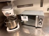 a microwave and a mixer on the counter in the kitchen