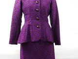 a close up of a purple dress and jacket on a mannequin