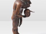 statue of a man holding a water jug on a marble base