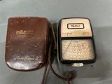 a brown case that has a meter in it and a brown case that has a meter in it