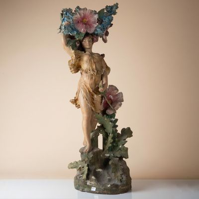 a figurine of a woman with flowers on her head