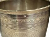 a large metal bowl with holes in it on a white surface