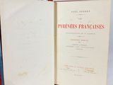 three books that are open on a white surface