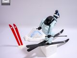 a figurine of a person on skis on a white surface