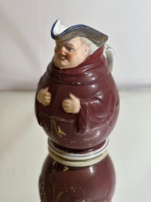 a figurine of a man with a hat on a table