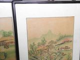 two framed pictures of a rural scene on the wall
