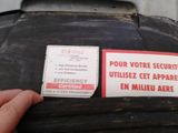 a sticker on the back of a black suitcase