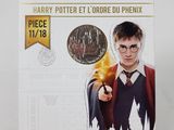 a close up of a coin with a harry potter holding a wand