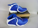 pair of blue and white basketball shoes sitting on top of a box