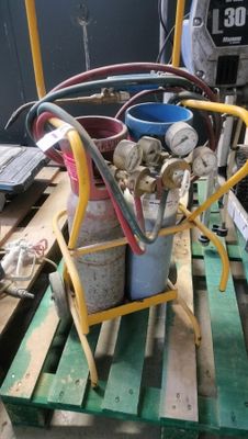 a stack of gas cans on a pallet in a warehouse