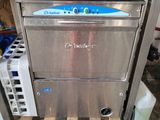 an image of a stainless steel counter top dishwasher with wine glasses on it