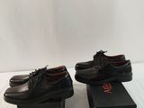 pair of men ' s black leather shoes with laces on them