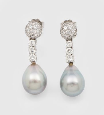 a pair of pearl and diamond earrings