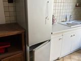 a kitchen with a refrigerator and a sink in it