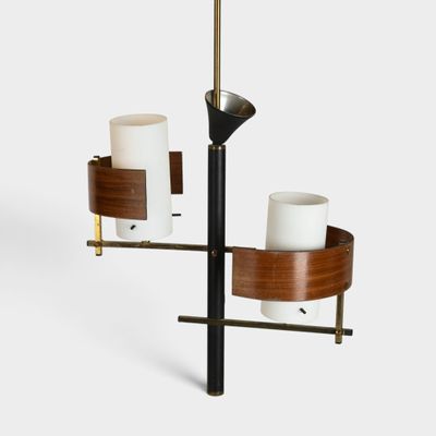 a close up of two candles on a stand with a candle holder
