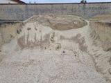 a large mound of sand in the middle of a dirt pit