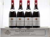 four bottles of red wine sitting on top of a white box